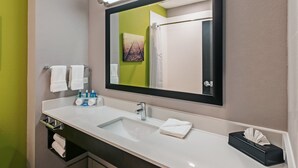 A bathroom with a white sink, a mirror, and a towel rack. - Holiday Inn Express & Suites Perryton by IHG (Perryton)