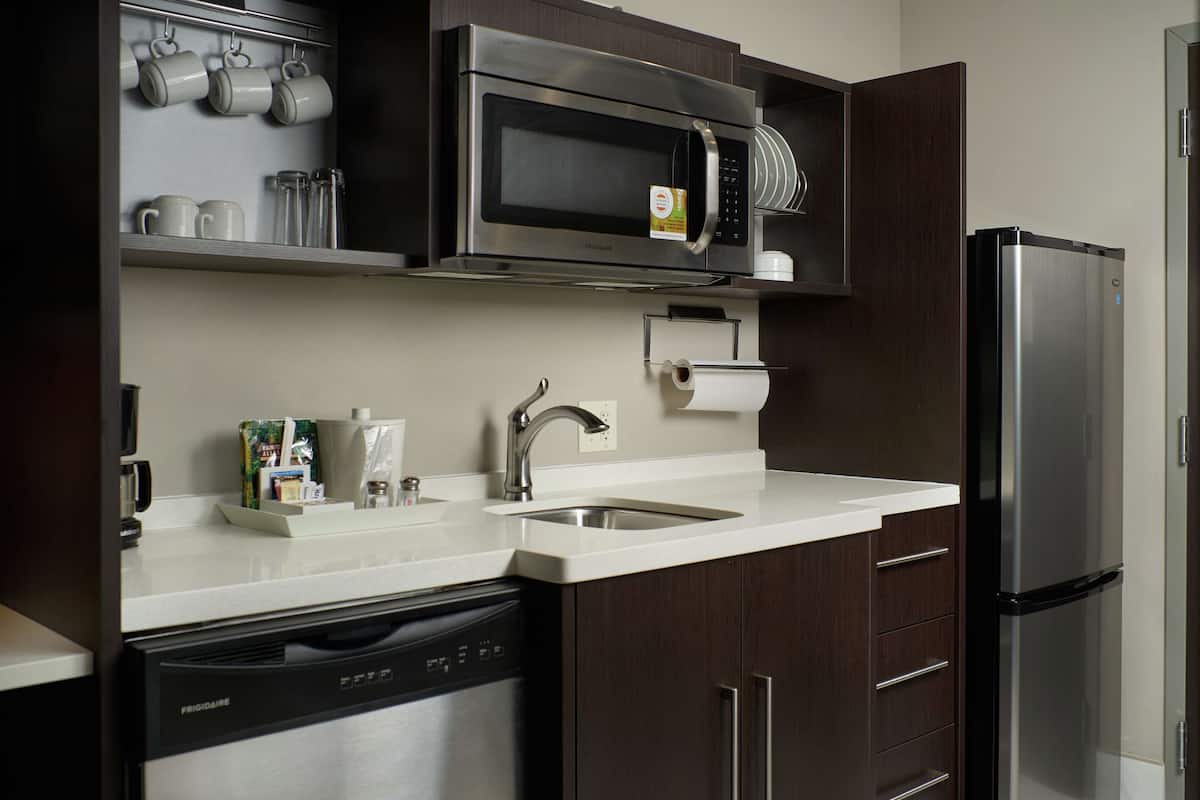 full-sized fridge, microwave, dishwasher, cookware/dishes/utensils