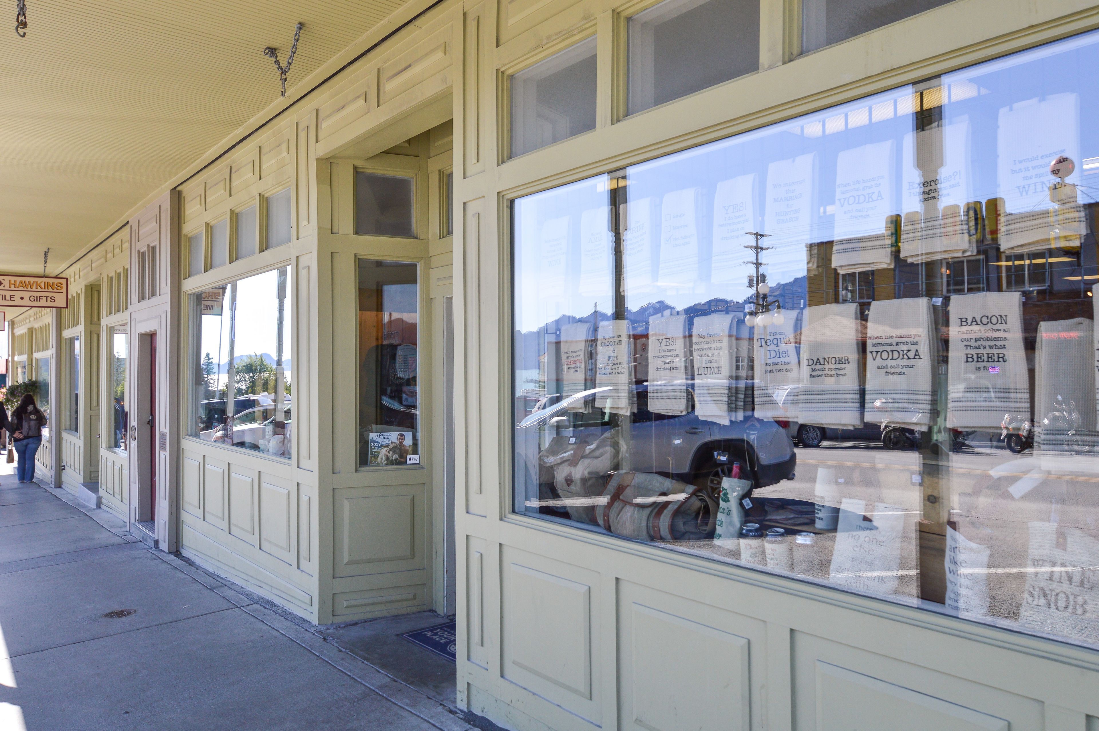 A storefront with large windows displaying various products.