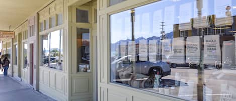 A storefront with large windows displaying various products.