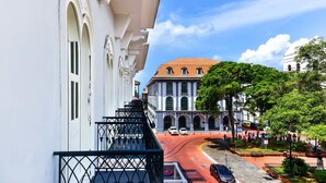 A building with a balcony and a street view.