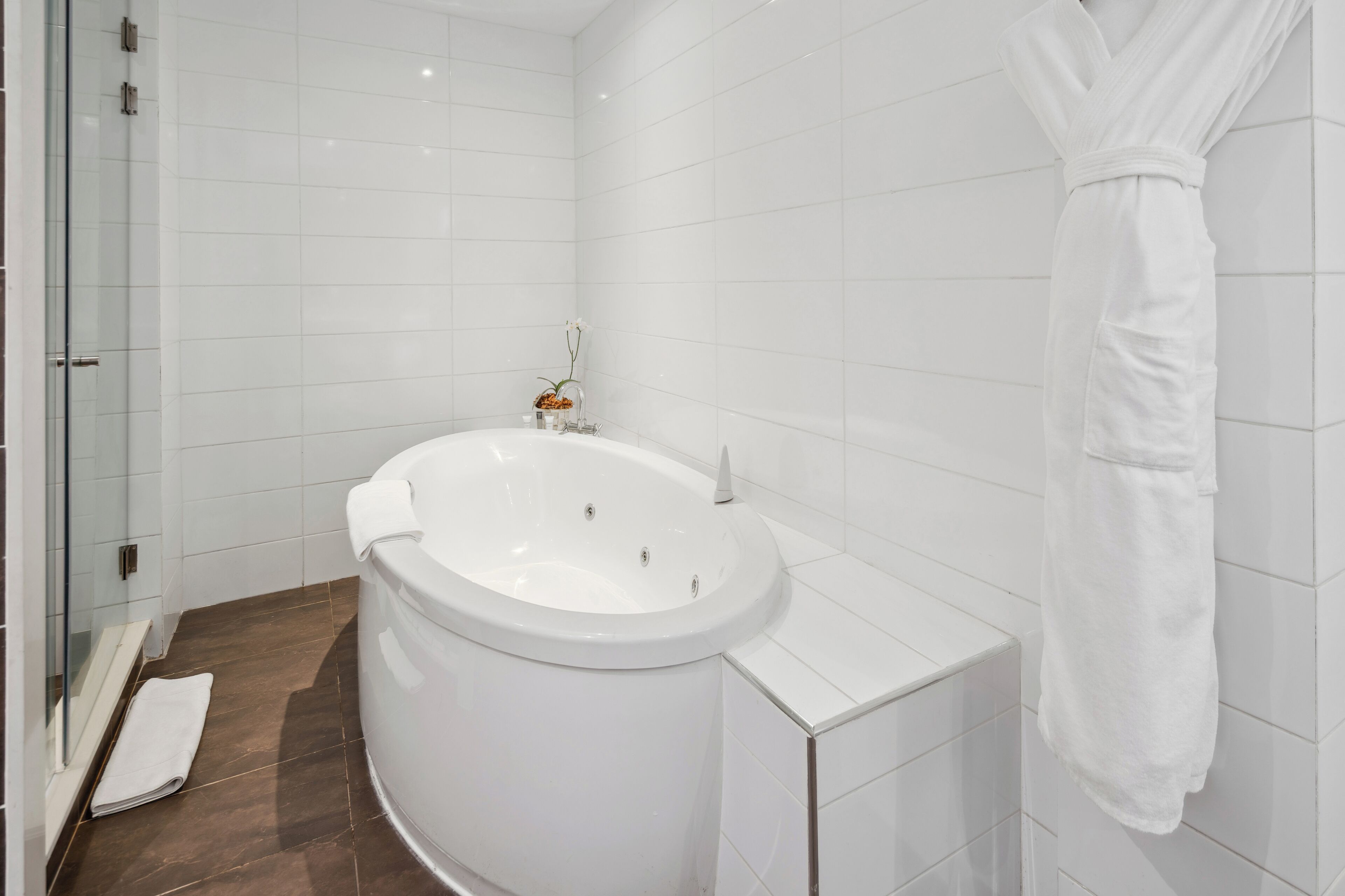 presidential suite, 1 king bed, jetted tub | bathroom | free toiletries, hair dryer, slippers, towels