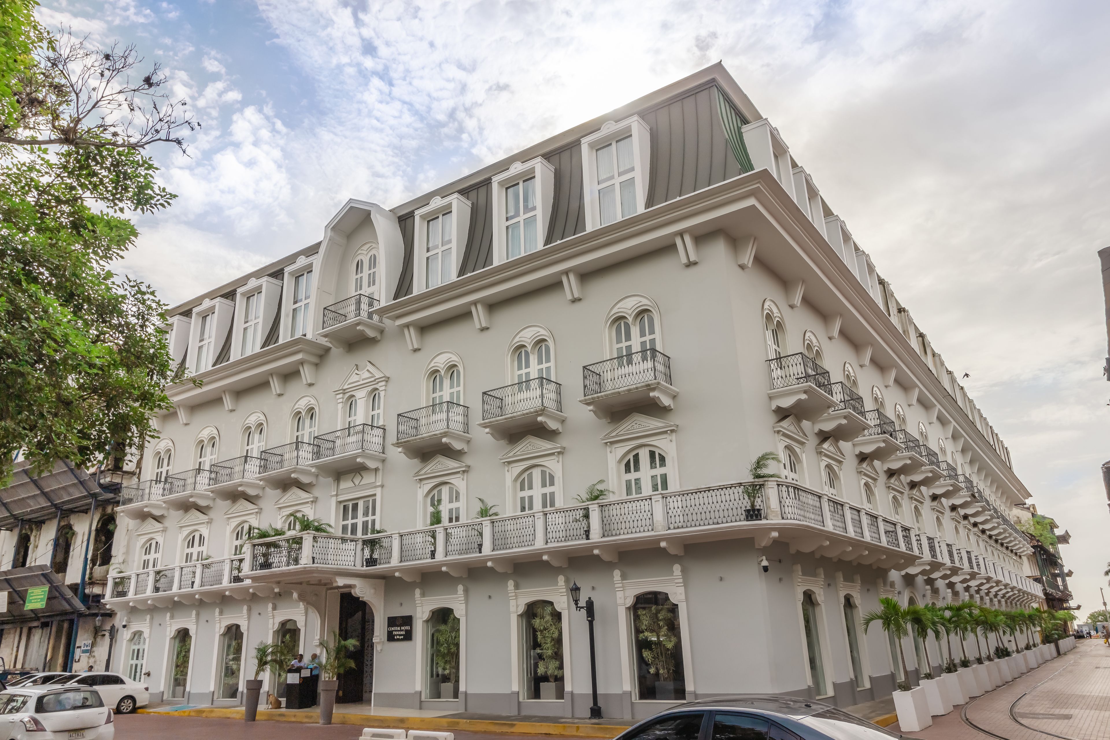 A multi-story hotel with balconies, large windows, and a classic architectural style.