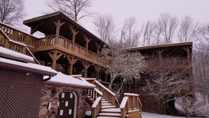 A wooden cabin with a covered porch and a staircase leading to a second level. - The Inn at Dresden (Dresden)