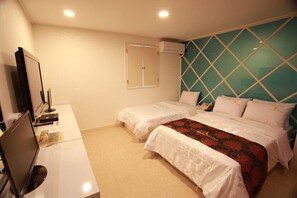 A hotel room with two beds, a desk with a computer, and a large window with a geometric pattern. - La Nuit Hotel (Jeonju)