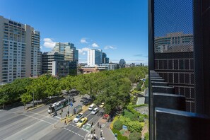 A cityscape with modern buildings, a tram line, and a green park area. - Wyndel Apartments St Kilda Views (Melbourne)