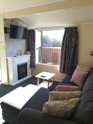 Studiosvit Deluxe - 1 kingsize-säng - eldstad - utsikt mot bergen (Adult Only) | Vardagsrum | 32-tums LED-tv med digitalkanaler, tv och eldstad