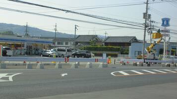 A street view with a Lawson station sign, vehicles, and a construction barrier.