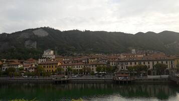 A riverside town with historic buildings, a prominent church tower, and a bridge.