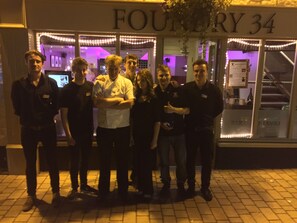 A group of people standing in front of a building with a sign that reads "FOURTHRY 34". - Foundry 34 (Penrith)