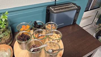 A kitchen counter with various food items in jars and a toaster.