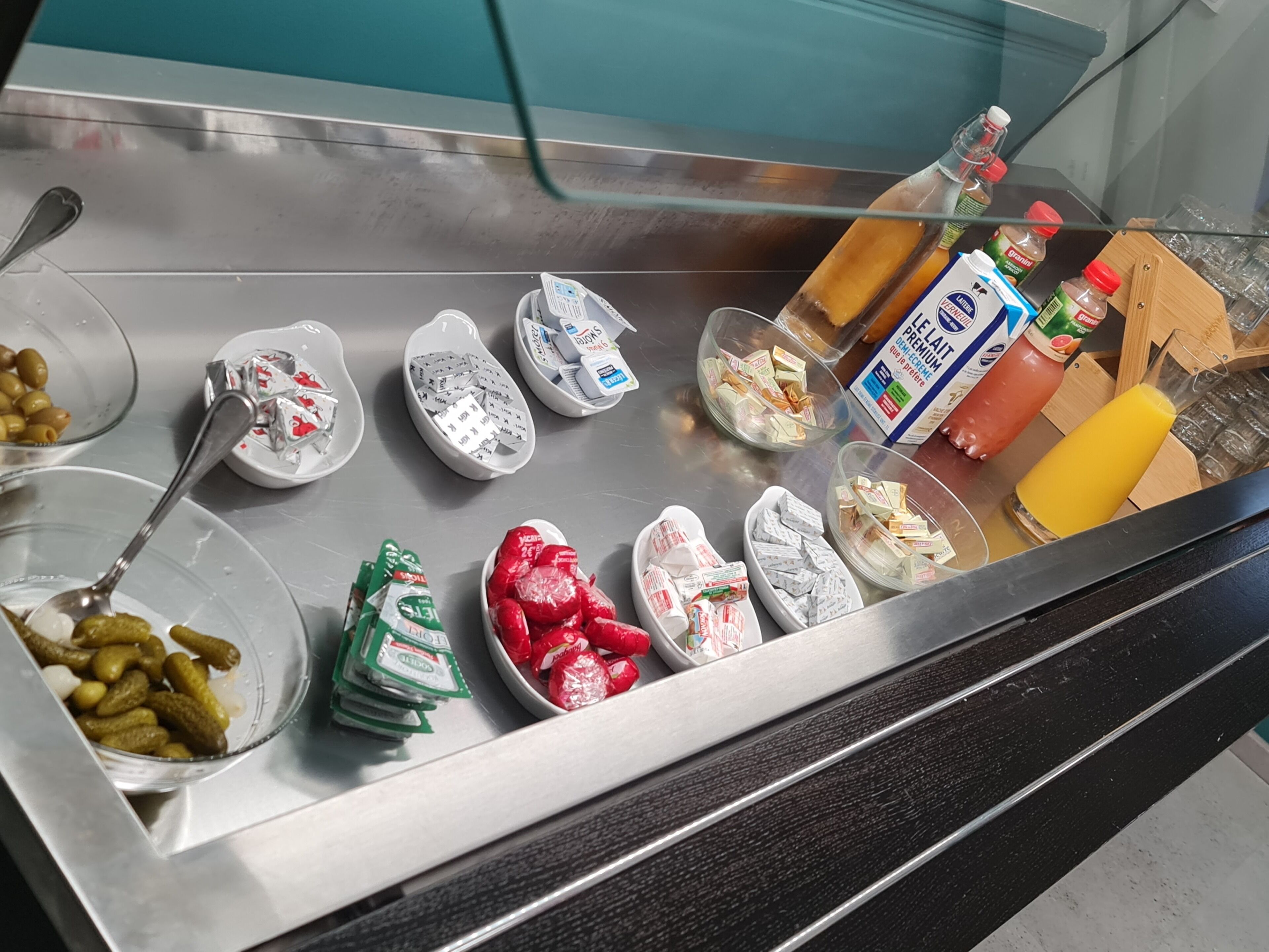 A buffet spread with various food items and condiments.