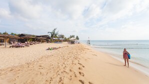 A beach with sun loungers, umbrellas, and a clear sky. - Blue Paradise Resort (Phu Quoc)
