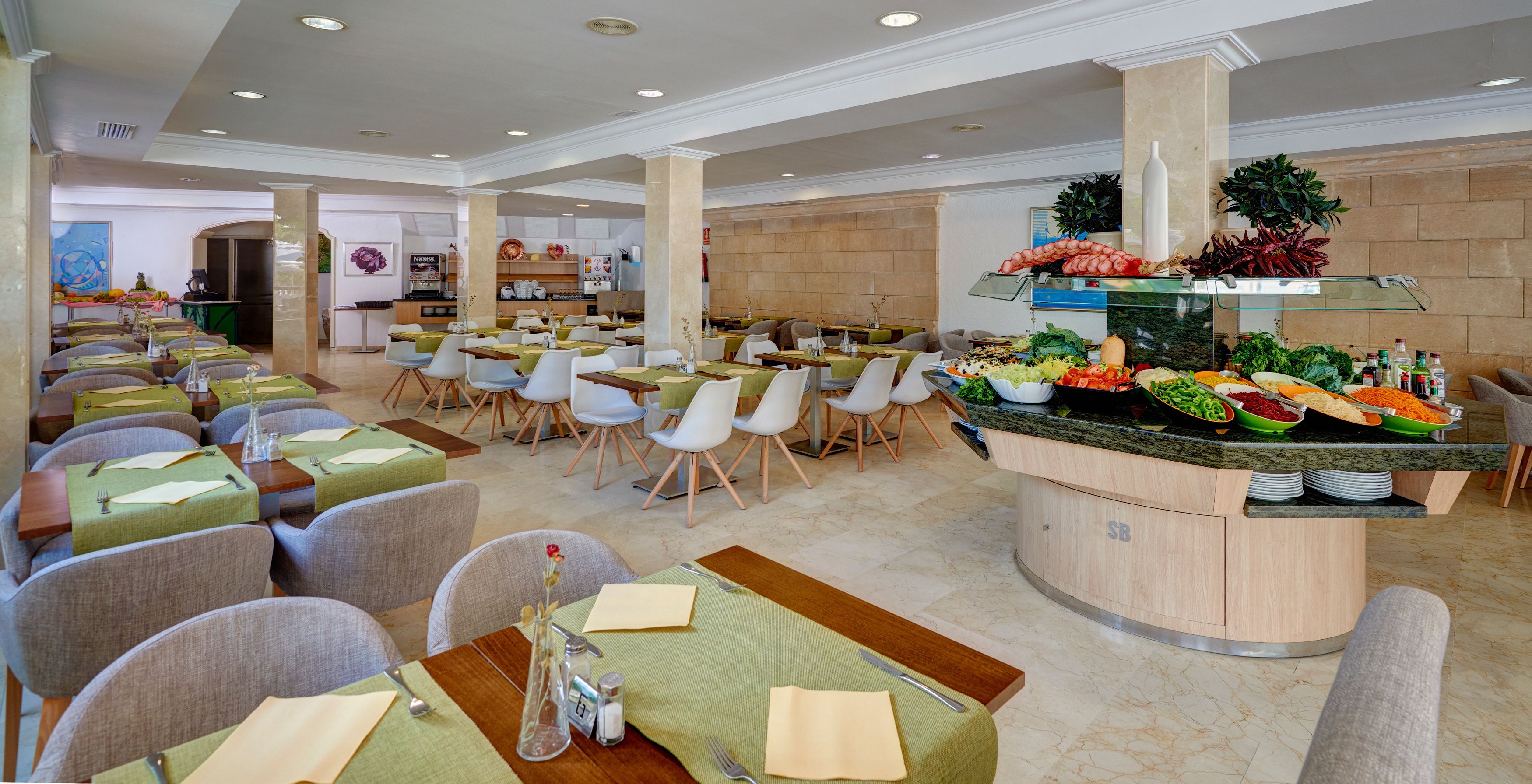 A buffet-style restaurant with multiple seating areas, a central buffet counter with a variety of food items, and a clean, modern interior design.