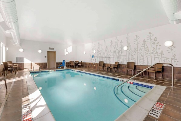 An indoor swimming pool with clear water, surrounded by lounge chairs and a wall mural. - Sleep Inn & Suites Cumberland - LaVale (Cumberland)