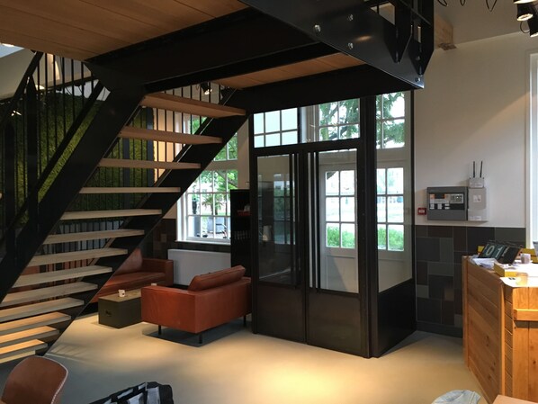 A modern kitchen with a built-in refrigerator, a wooden cabinet, and a small table.
