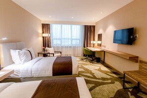Minibar, escritorio, cortinas blackout y tabla de planchar con plancha 