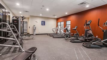 A gym with treadmills, ellipticals, and weight machines.