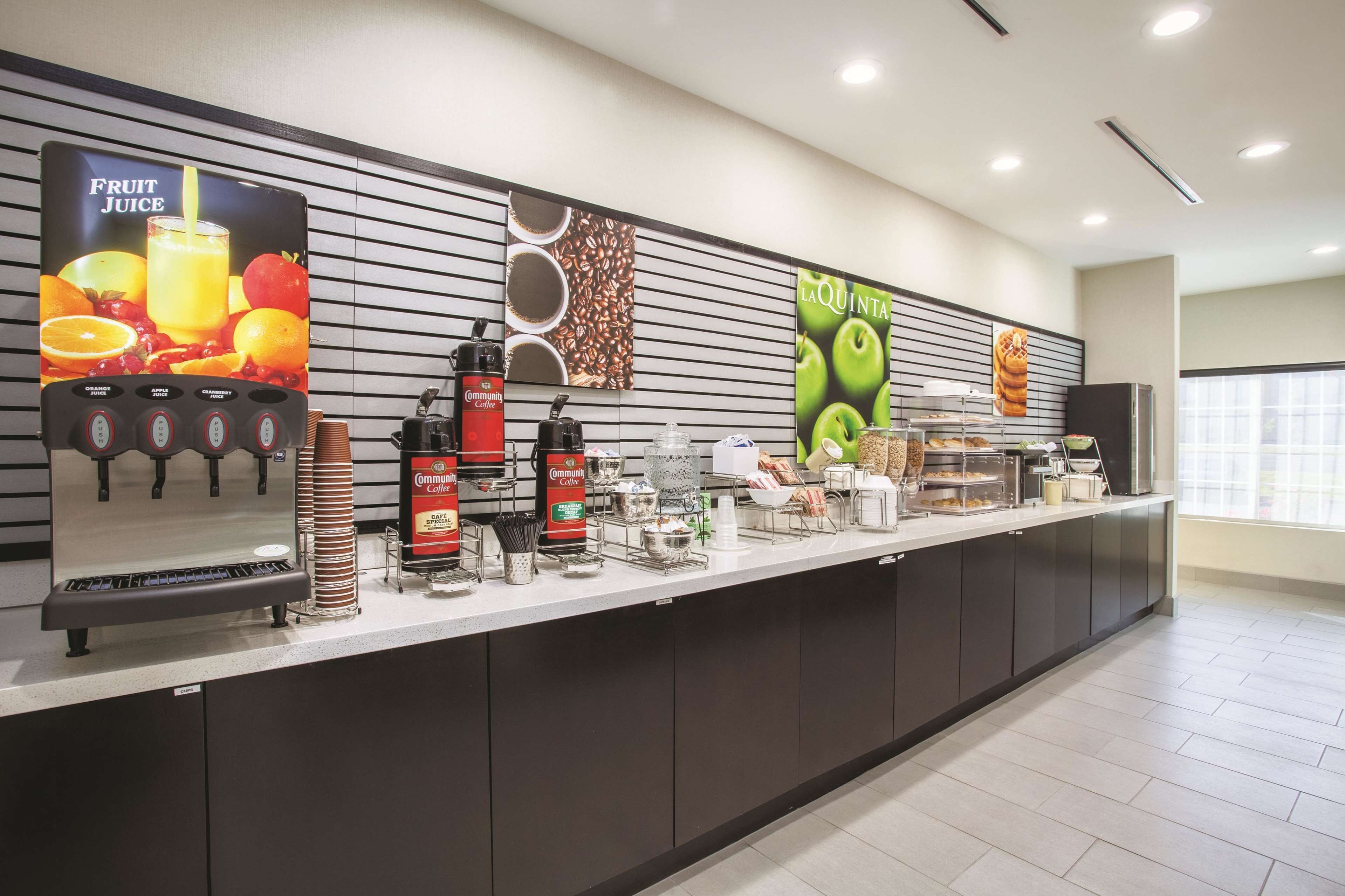 A self-service beverage station with various drink dispensers and a coffee machine.
