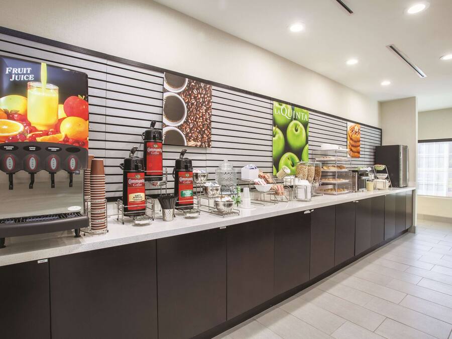 A self-service beverage station with various drink dispensers and a coffee machine.