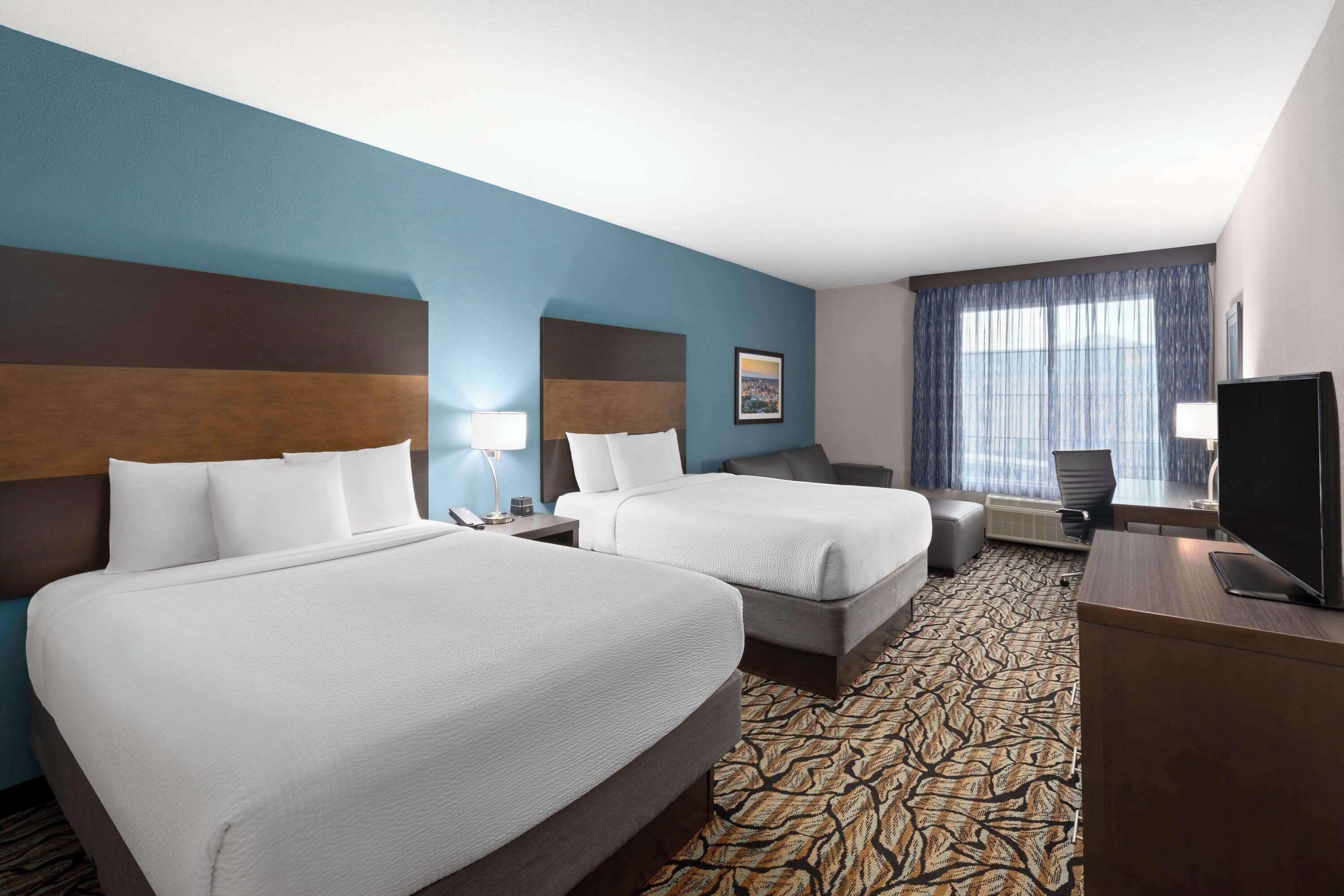 deluxe room, 2 queen beds, non smoking | premium bedding, pillow-top beds, desk, soundproofing