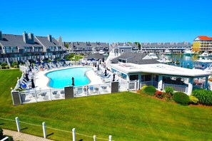 A hotel with a swimming pool, a covered deck, and a view of the marina. - Harbour Island 403m 2 Bedroom Condo by RedAwning (Ocean City)