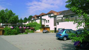 Un quartier résidentiel avec des maisons, une allée pavée et des voitures garées.