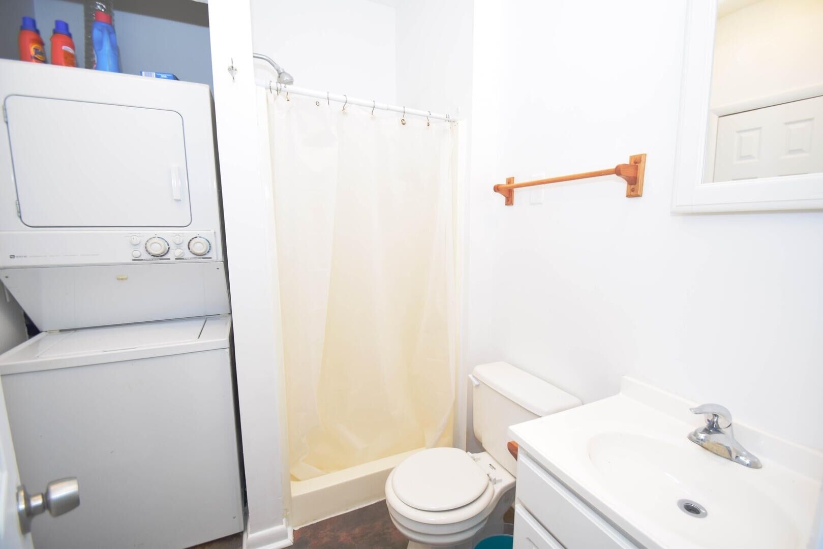 Ein kleines Badezimmer mit Toilette, Waschbecken und Duschvorhang.