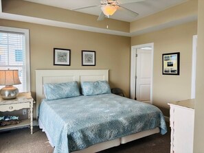 A bedroom with a bed, a ceiling fan, a nightstand, and a dresser. - 1 Fine Day 4 Bedroom Home by RedAwning (Supply)