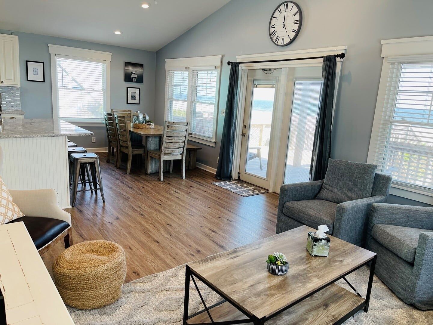 A spacious living area with a dining table, a sofa, and a coffee table.