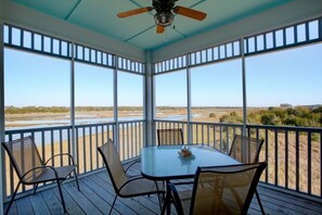 A covered outdoor area with a table and chairs, large windows, and a ceiling fan. - Belle Moor 3 Bedroom Home by RedAwning (Supply)