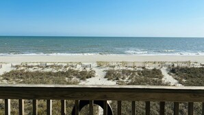 A beach view with a wooden deck and sandy dunes. - Great Place 5 Bedroom Home by RedAwning (Supply)