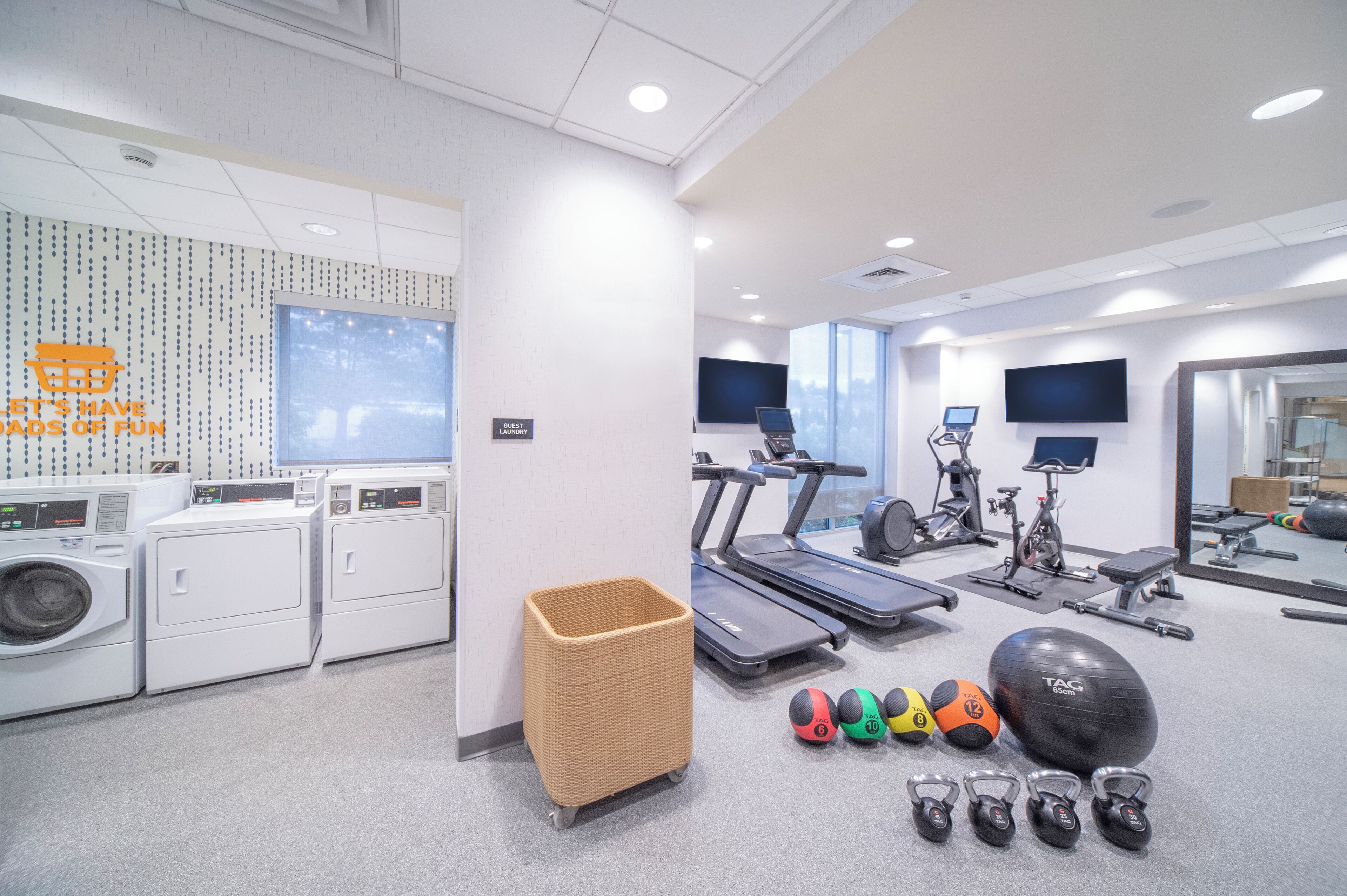 A gym with stationary bikes, treadmills, and exercise balls.