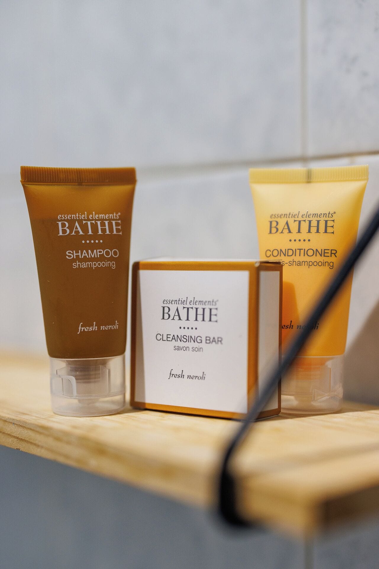 Three bottles of Bathe products: shampoo, conditioner, and cleansing bar.