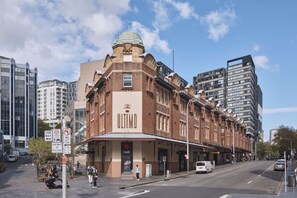 A historic building with a prominent dome and a sign reading "The Ultimo."