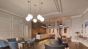 Una moderna zona de recepción con pared de ladrillo, mostrador de recepción, disposición de asientos y un gran ventanal.