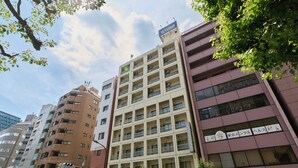 A multi-story building with a mix of residential and commercial spaces, including a visible restaurant on the ground floor. - Tabist Hotel Tetora Ikebukuro (Tokyo)