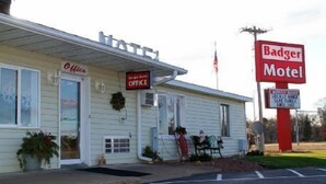 A building with a sign for 'Badger Motel' and a 'Drive Thru' sign. - Badger Motel (Chippewa Falls)