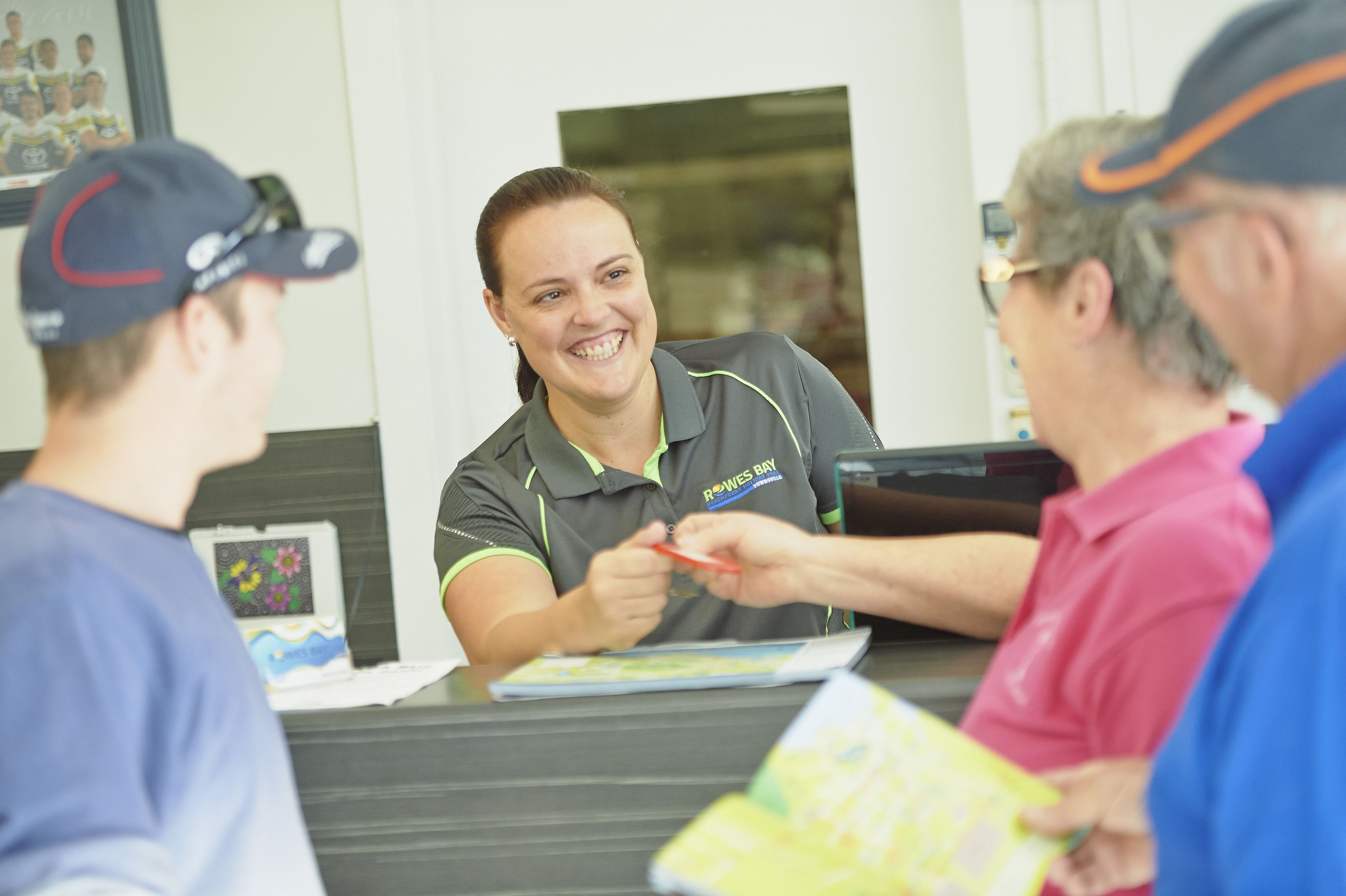 A reception desk with a staff member interacting with guests.