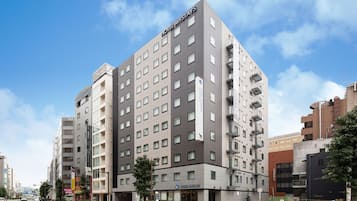 A multi-story hotel with a modern design, featuring a prominent sign at the top.