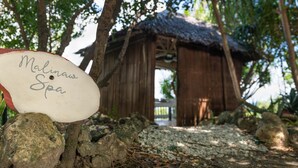 A wooden structure labeled 'Malinaw Spa' surrounded by trees and rocks. - Granada Beach Resort - Adults Only (Boljoon)