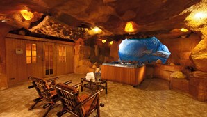 A room with wooden furniture, a large aquarium, and a wooden cabinet. - Xperience Kiroseiz Premier (Sharm El Sheikh)
