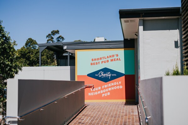 A sign for Shortland's Best Pub Meal at The Shorty Hotel, indicating it's a friendly neighborhood pub. - Shortland Budget Accommodation (Shortland)