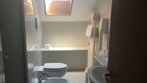 A compact bathroom with a skylight, a toilet, a bidet, and a sink. - Hotel Residence D'Azeglio (Turin)