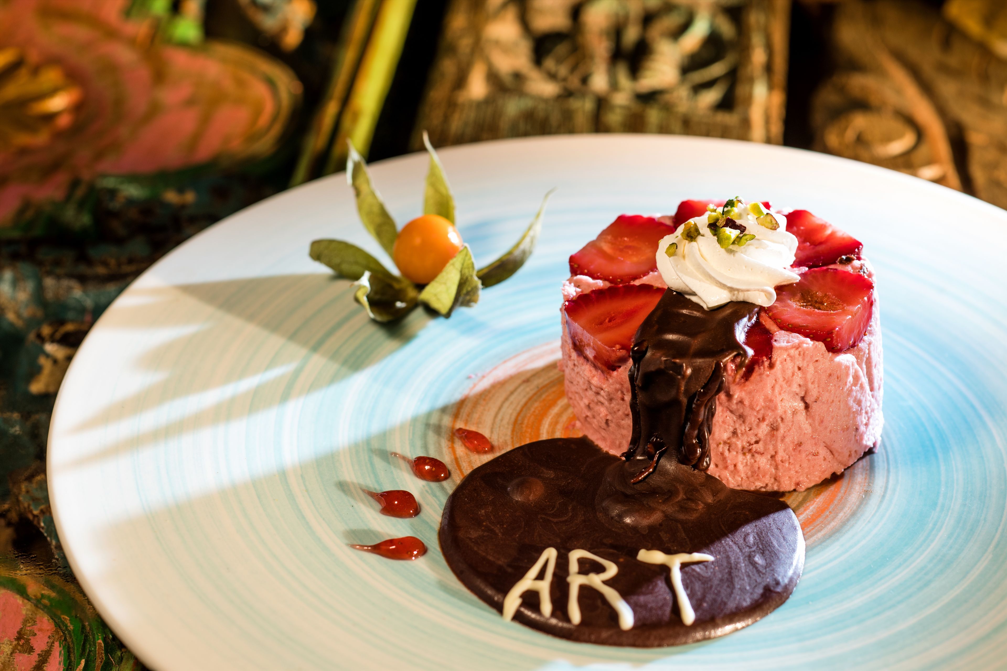 A dessert on a plate with the word "ART" on it.