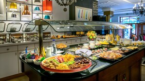 A buffet with a variety of food items and a glass-top serving station. - A for Art Design Hotel (Thasos)