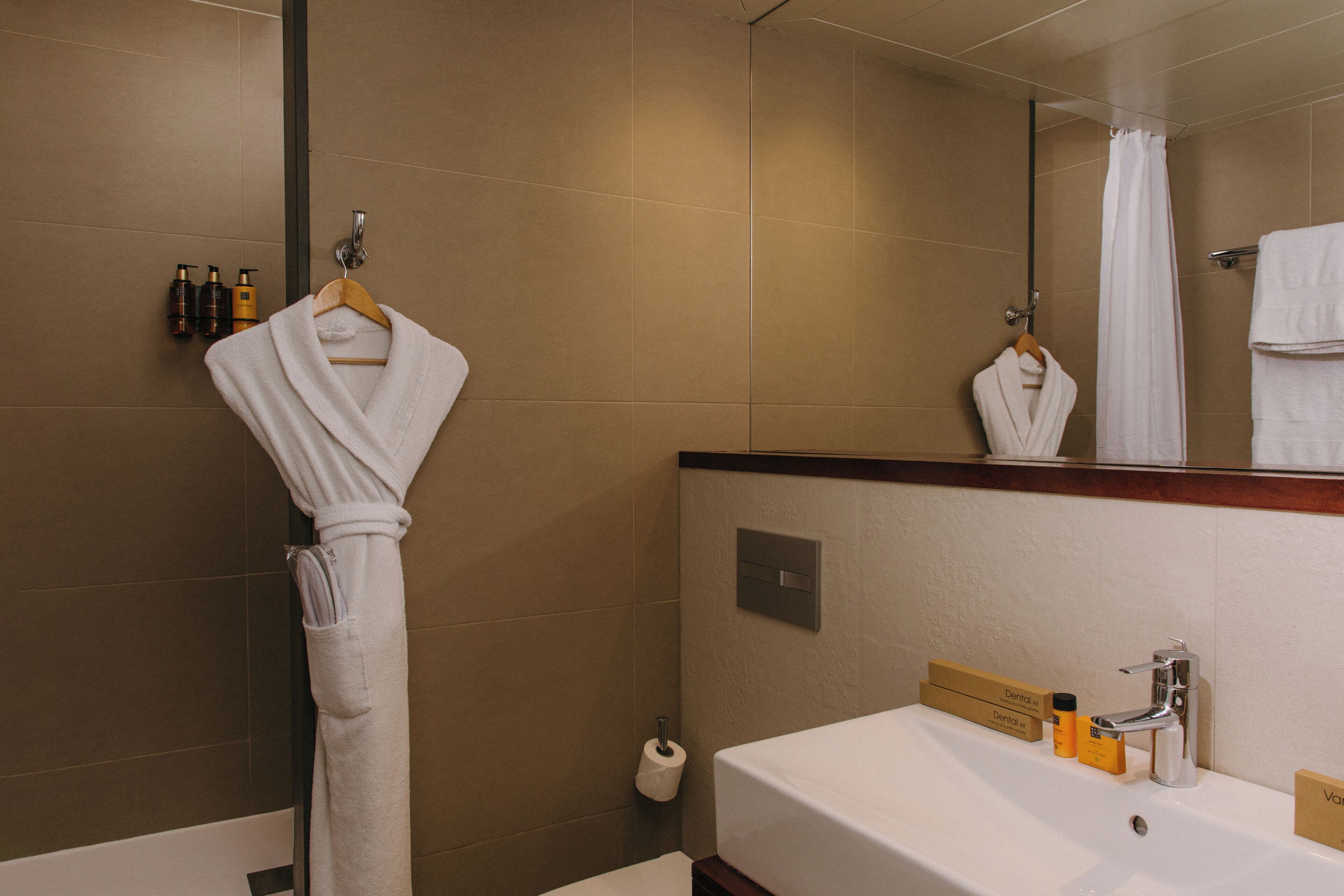 A bathroom with a sink, mirror, and towel rack.