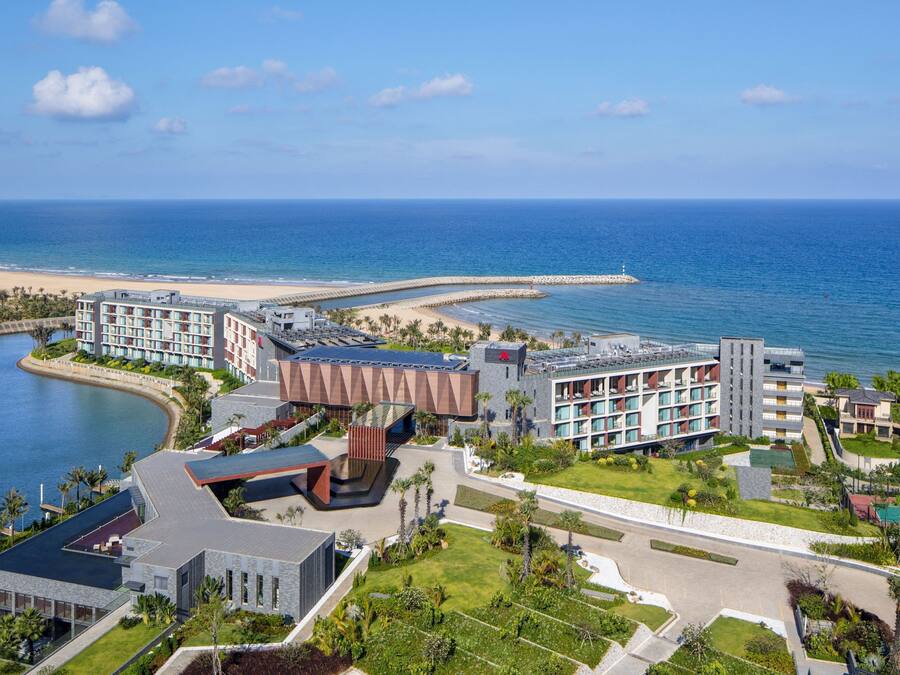 A resort with multiple buildings, a beach, and a marina.
