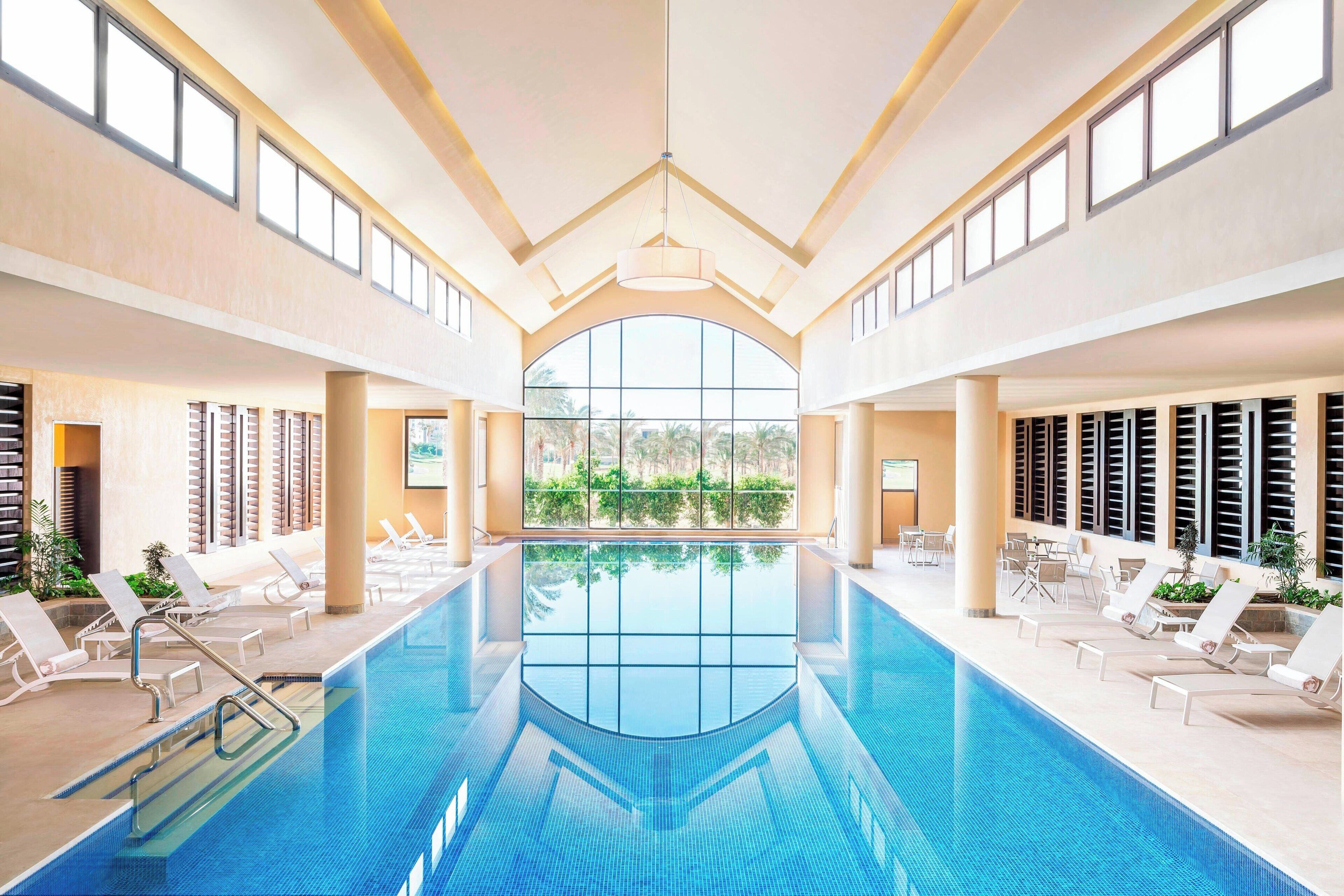 indoor pool, outdoor pool, pool umbrellas, pool loungers
