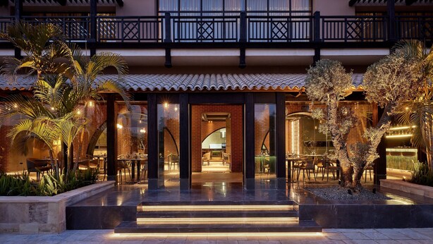 A hotel entrance with a covered patio, outdoor seating, and a well-lit pathway. - The Westin Cairo Golf Resort & Spa, Katameya Dunes (New Cairo)